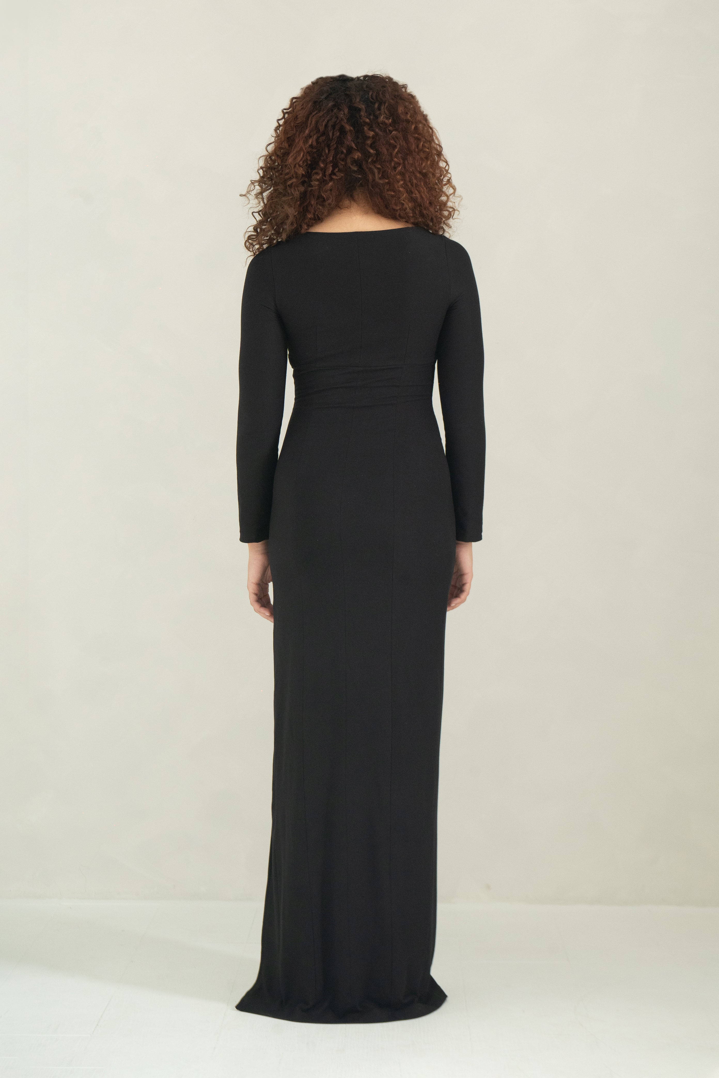 Long sleeve floor length black evening dress with a ring detail, bust cutout and front slit