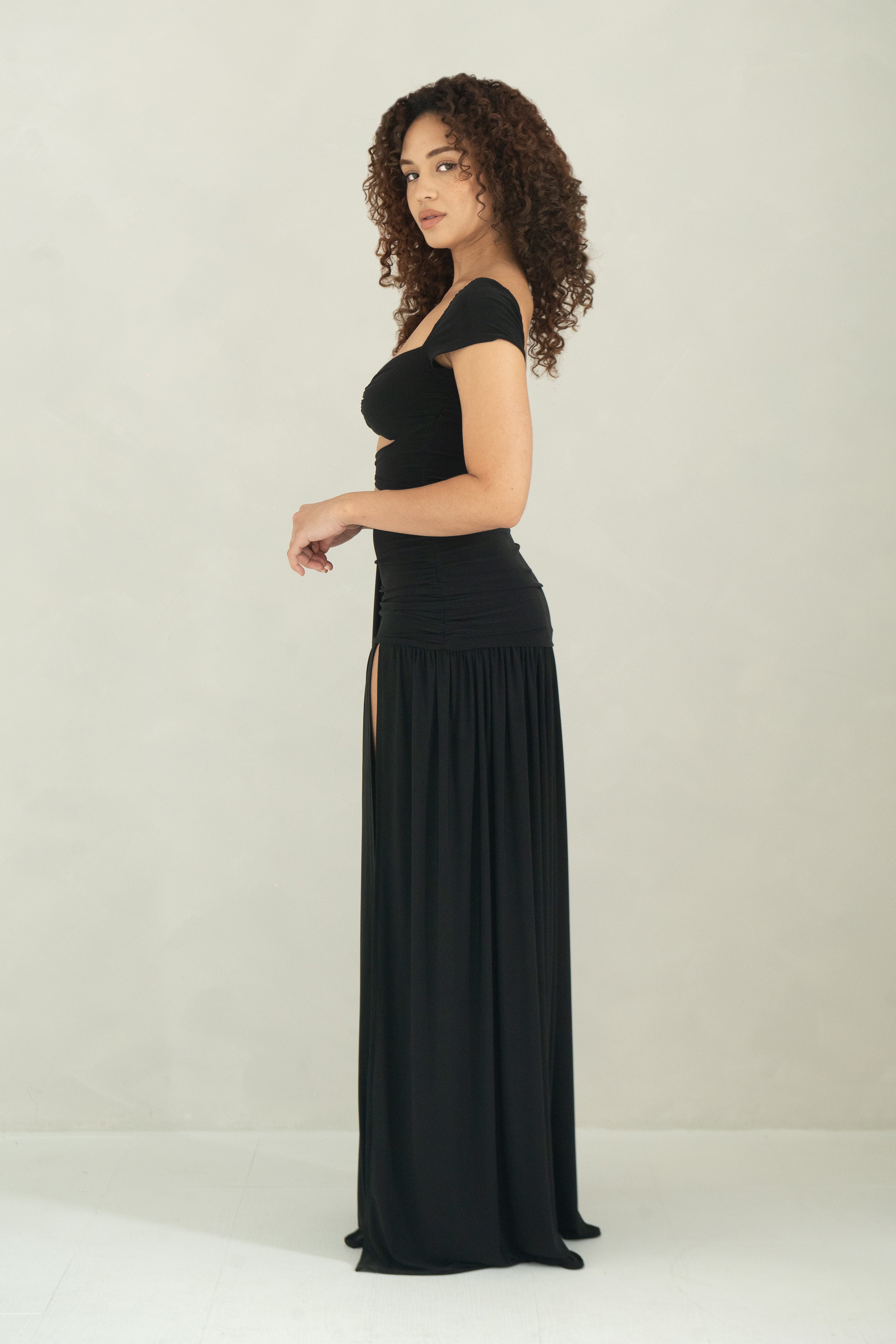 Floor length black dress with cap sleeves, ring detail and front slit